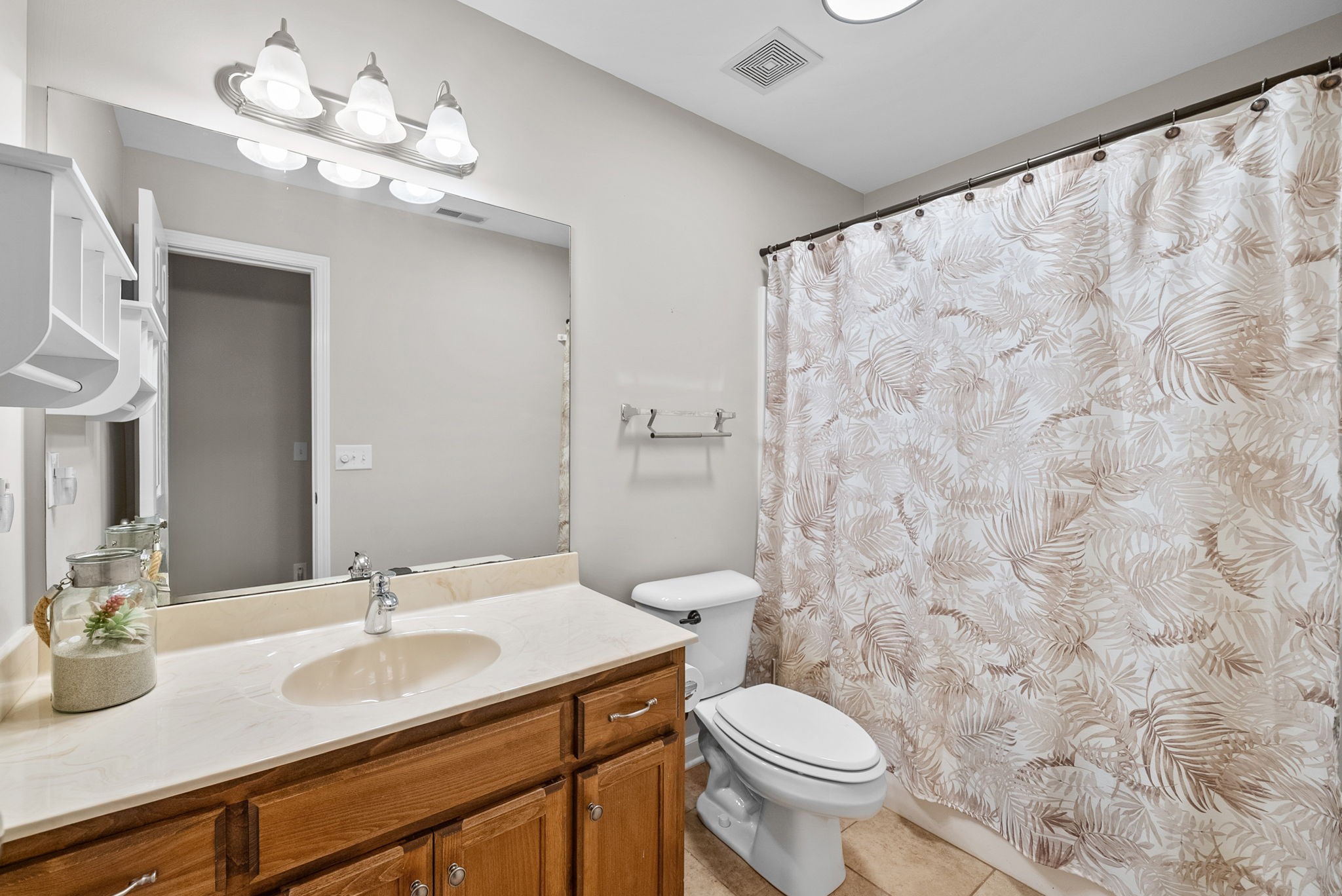 1161 Cynthia Lane Spring Hill, TN 37174 - Photo 21 of 42 a bathroom with a granite countertop sink a toilet and a mirror