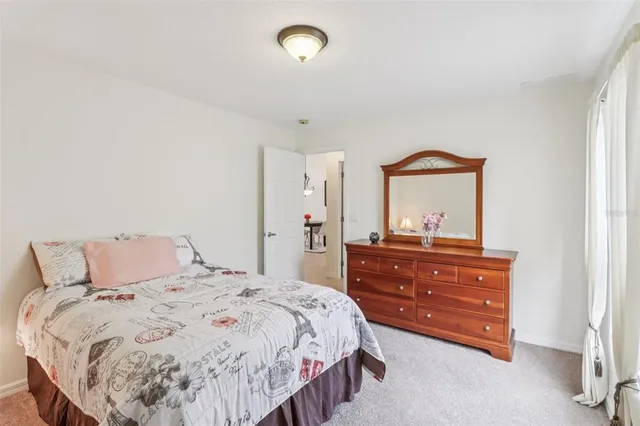 a living room with furniture a flat screen tv and a large window