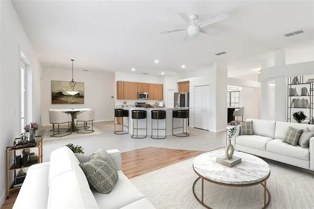 a living room with furniture and kitchen view