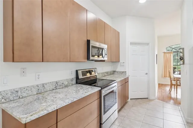 a kitchen with granite countertop a sink and a stove top oven