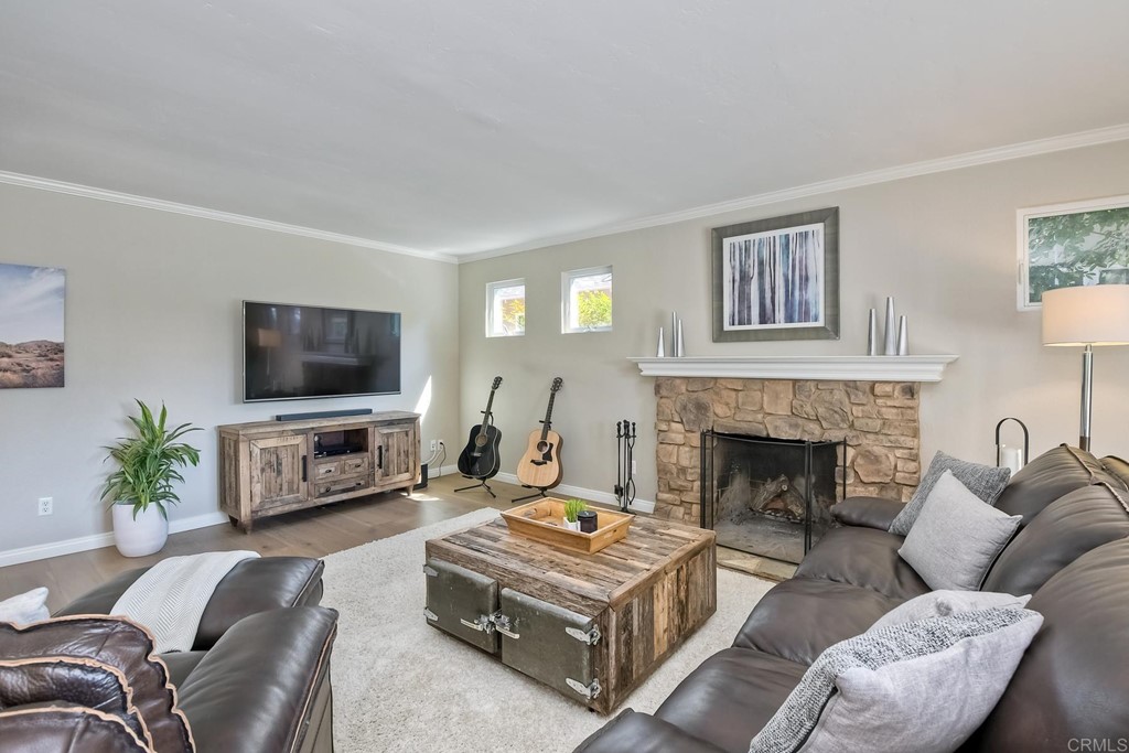 631 Dell Street Solana Beach, CA 92075 - Photo 12 of 36 a living room with furniture a flat screen tv and a fireplace