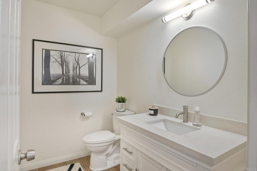 631 Dell Street Solana Beach, CA 92075 - Photo 13 of 36 a bathroom with a toilet a sink and mirror