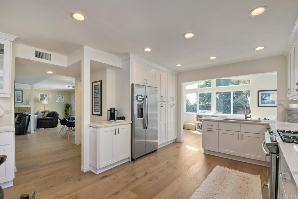 631 Dell Street Solana Beach, CA 92075 - Photo 17 of 36 a large kitchen with a lot of counter space and wooden floor