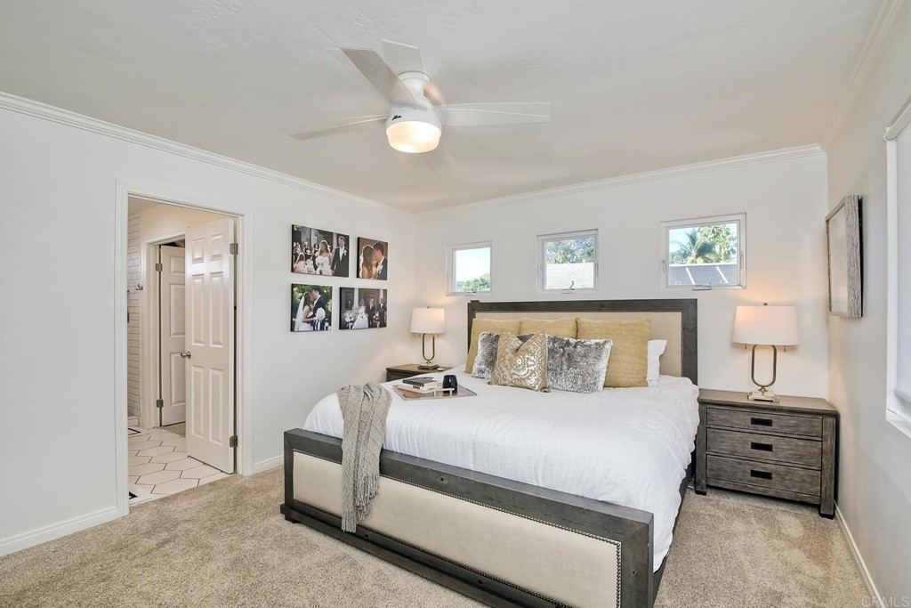 631 Dell Street Solana Beach, CA 92075 - Photo 23 of 36 a bedroom with a bed and a chandelier