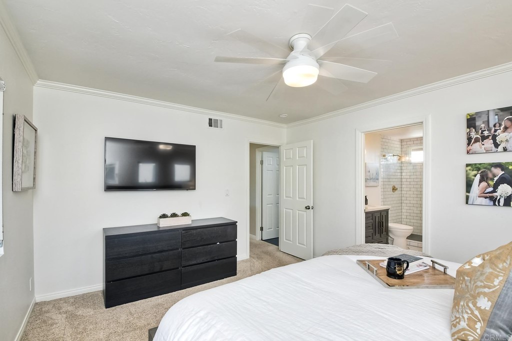 631 Dell Street Solana Beach, CA 92075 - Photo 24 of 36 a bedroom with a bed and a flat screen tv