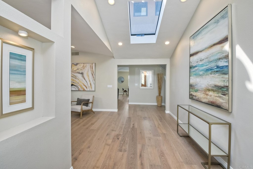 631 Dell Street Solana Beach, CA 92075 - Photo 4 of 36 a view of a hallway with wooden floor and a bathroom