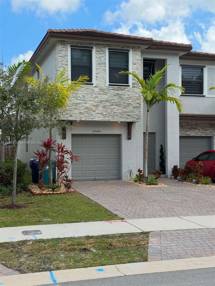 25265 Southwest 109th Avenue, Unit 25265 Homestead, FL 33032 - Photo 1 of 18 a front view of house with yard