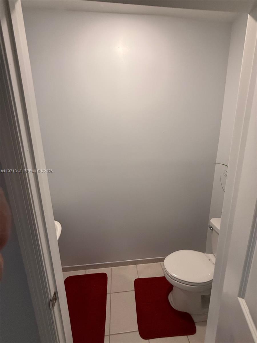 25265 Southwest 109th Avenue, Unit 25265 Homestead, FL 33032 - Photo 13 of 18 a bathroom with a toilet and a shower