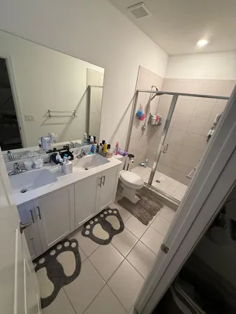 a bathroom with a sink mirror and toilet