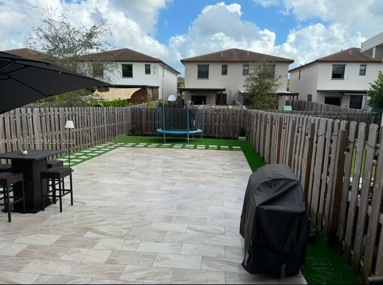 25265 Southwest 109th Avenue, Unit 25265 Homestead, FL 33032 - Photo 2 of 18 a view of a porch with wooden fence