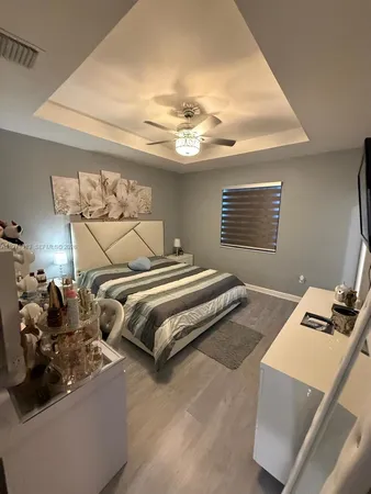 a bedroom with bed and window