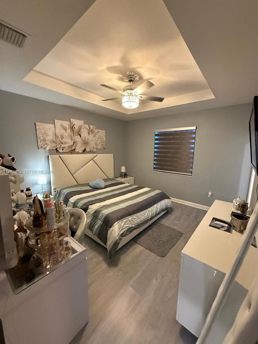 25265 Southwest 109th Avenue, Unit 25265 Homestead, FL 33032 - Photo 5 of 18 a bedroom with bed and window