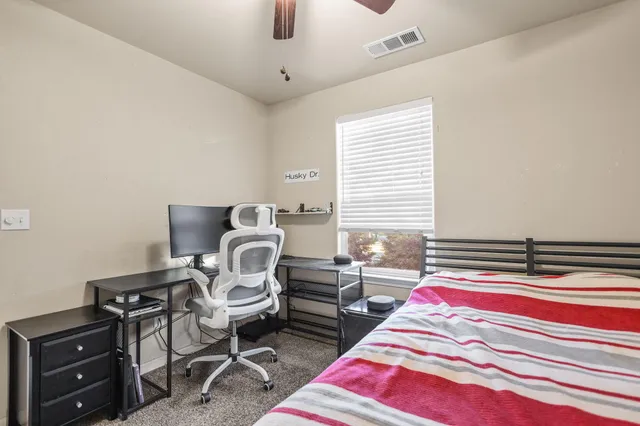 a bedroom with bed and chair