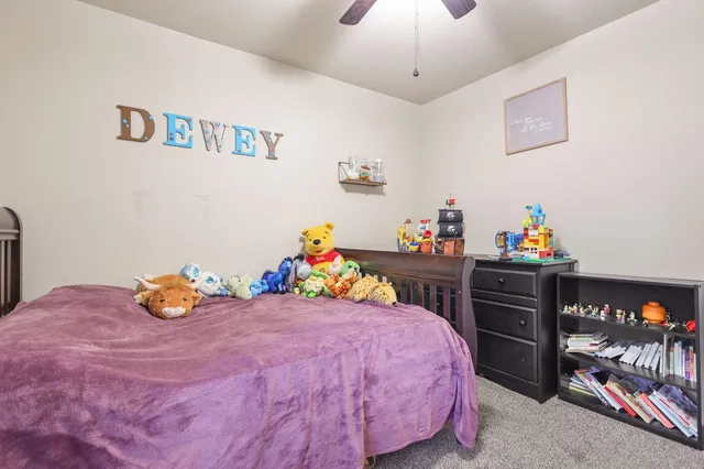 a bedroom with a bed and a dresser in it