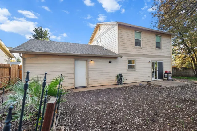 a front view of house with a garden