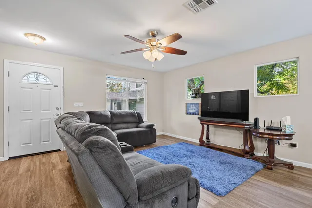 a living room with furniture and a flat screen tv