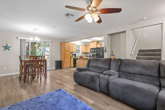 a living room with furniture and a view of dining room