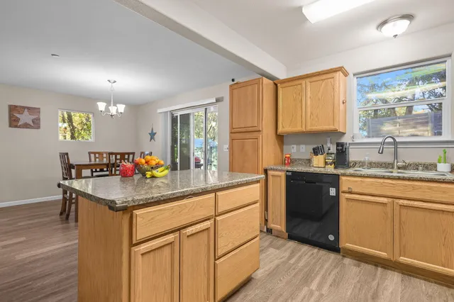 a kitchen with stainless steel appliances granite countertop a sink stove and cabinets