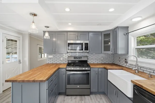 a kitchen with stainless steel appliances granite countertop a stove and a sink