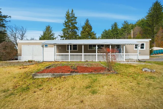 a view of house with swimming pool and yard