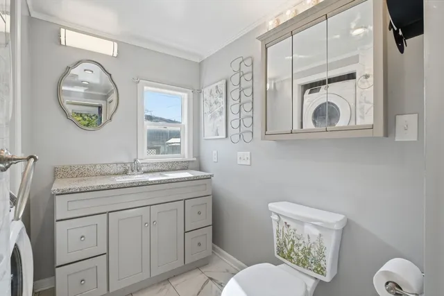 a bathroom with a toilet a sink and a mirror