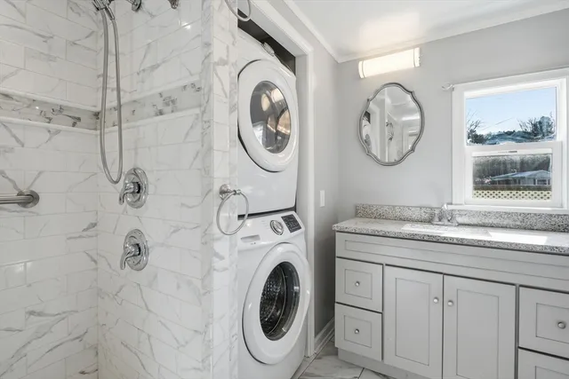 a bathroom with a granite countertop toilet sink and mirror
