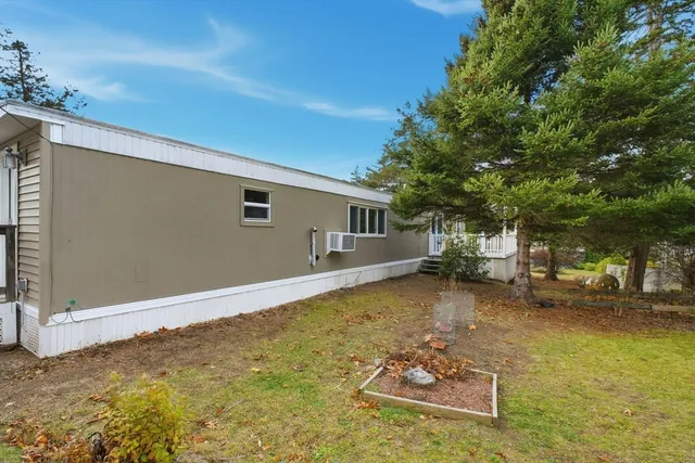 a backyard of a house with table and chairs