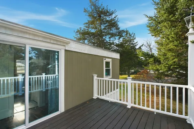 a view of backyard with a deck and wooden floor