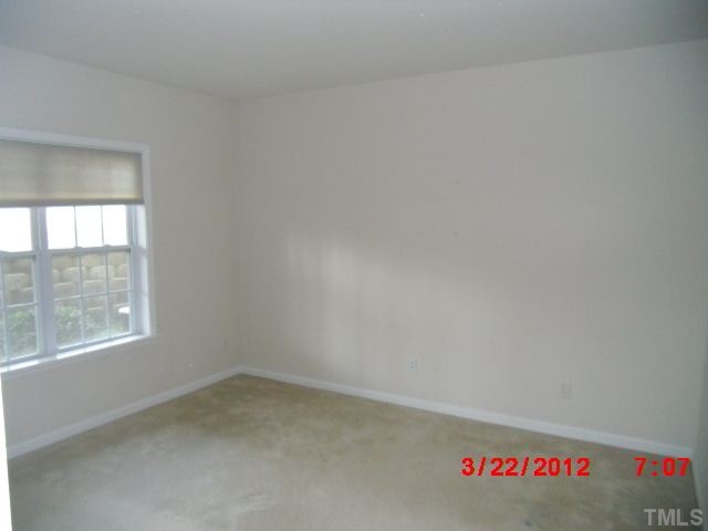 7111 Lovko Lane Raleigh, NC 27613 - Photo 2 of 8 an empty room with a window