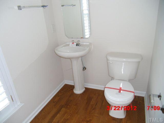7111 Lovko Lane Raleigh, NC 27613 - Photo 5 of 8 a bathroom with a toilet and a sink