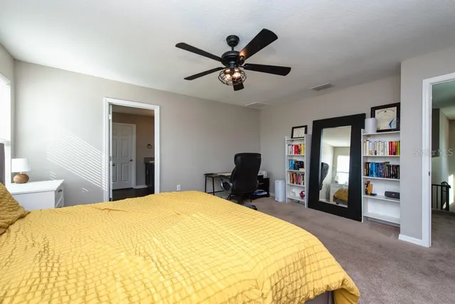 a bed room with a bed and a chair