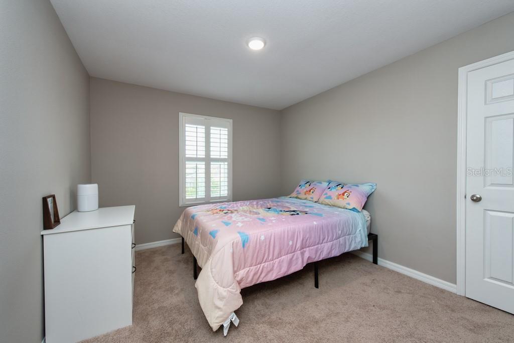 14617 Brumby Ridge Avenue Lithia, FL 33547 - Photo 22 of 46 a bedroom with a bed and window