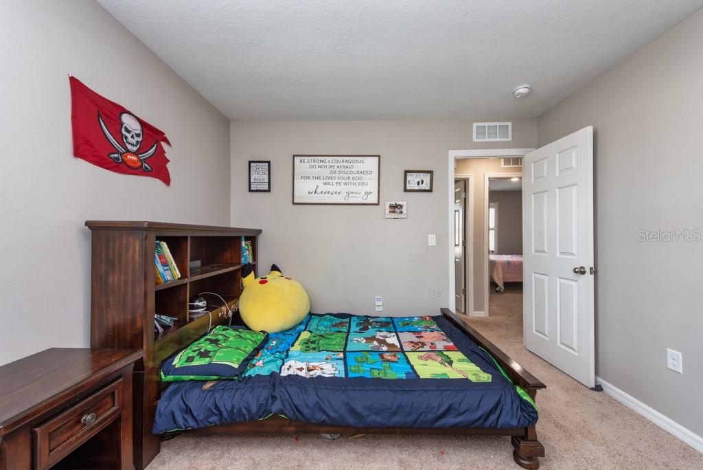 14617 Brumby Ridge Avenue Lithia, FL 33547 - Photo 27 of 46 a bedroom with bed and painting on the wall