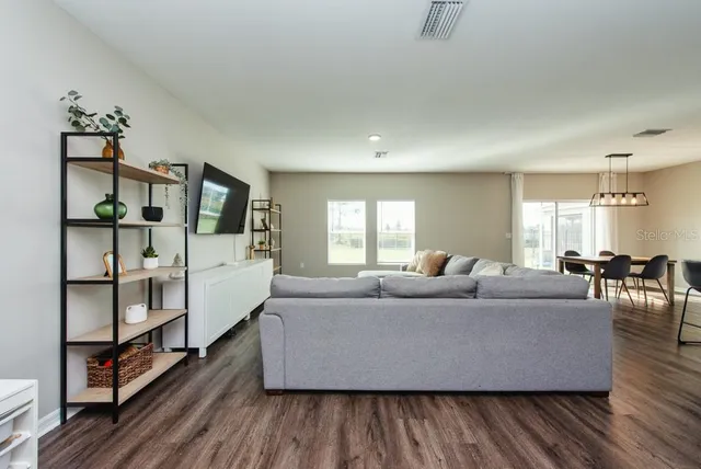 a living room with furniture and wooden floor