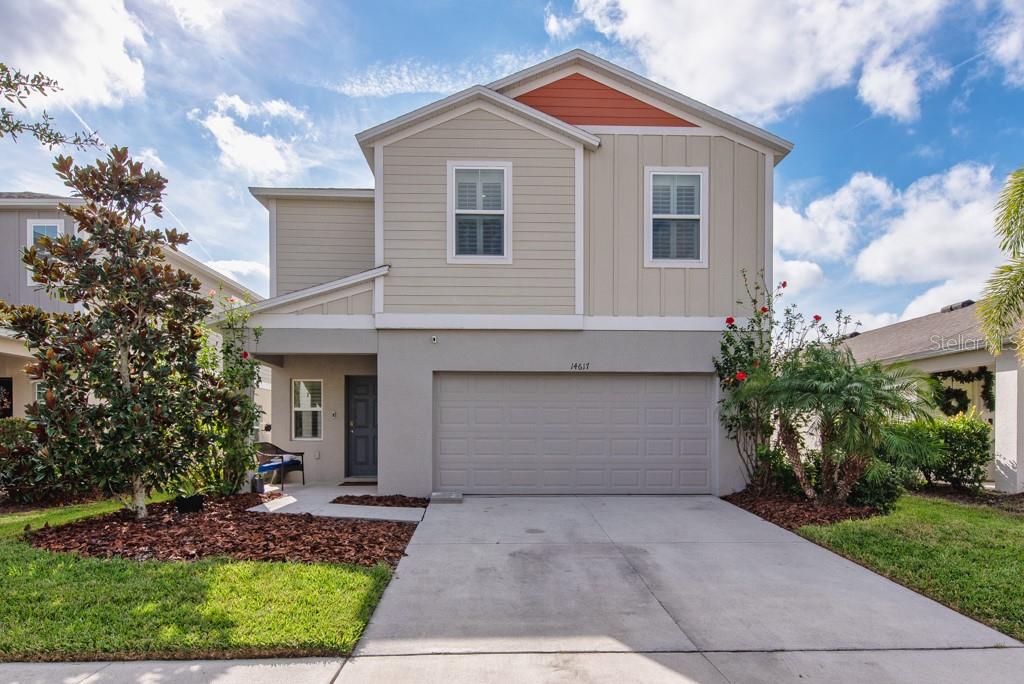 14617 Brumby Ridge Avenue Lithia, FL 33547 - Photo 34 of 46 a front view of a house with a yard and garage