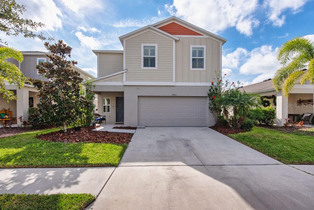 14617 Brumby Ridge Avenue Lithia, FL 33547 - Photo 35 of 46 a front view of a house with a yard and potted plants