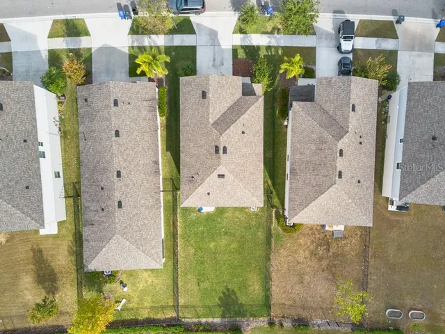 an aerial view of residential houses with outdoor space