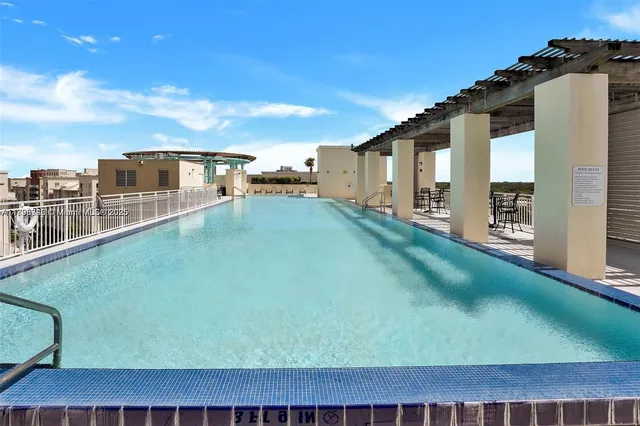 a view of a swimming pool with an outdoor seating