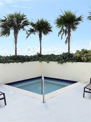 a view of a patio with table and chairs and potted plants