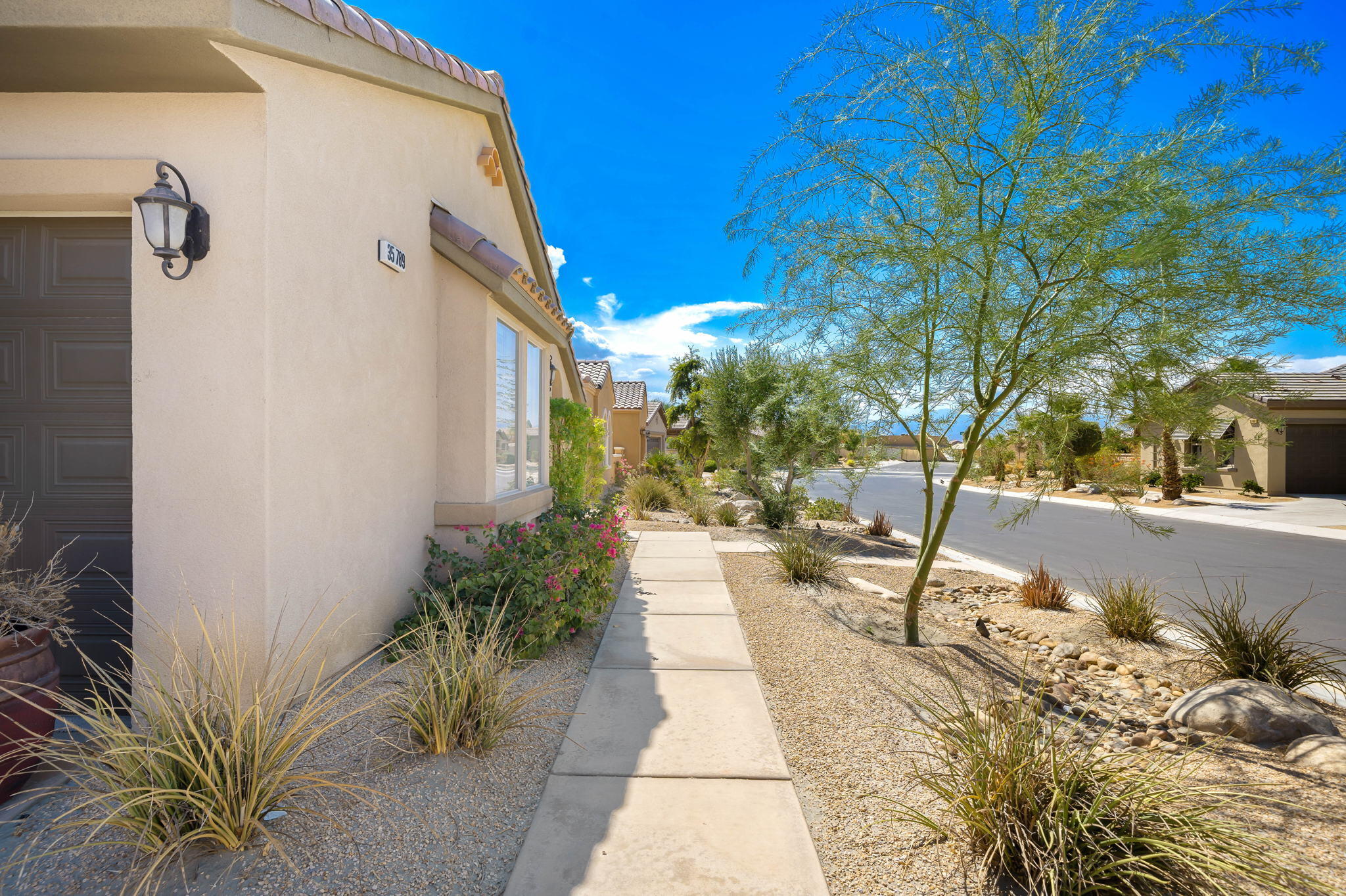 35789 Raphael Drive Palm Desert, CA 92211 - Photo 6 of 15 a pathway of a house with a yard