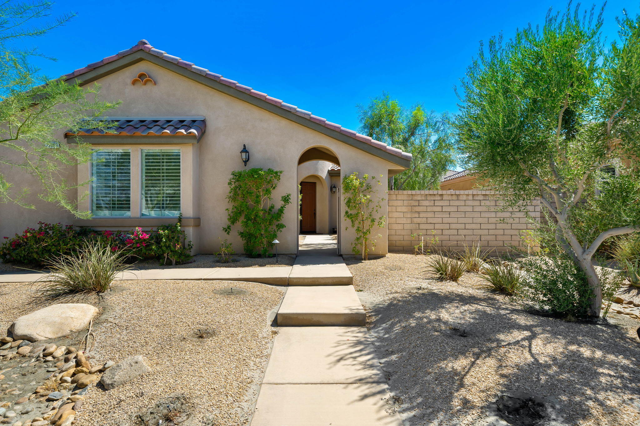 35789 Raphael Drive Palm Desert, CA 92211 - Photo 7 of 15 a front view of a house with a yard
