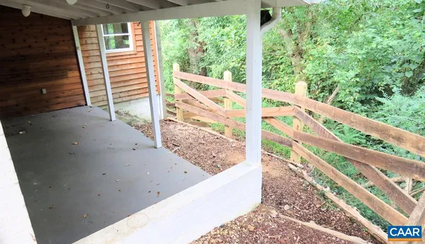 a view of a balcony with wooden floor and fence