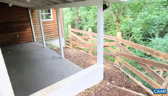 a view of a balcony with wooden floor and fence