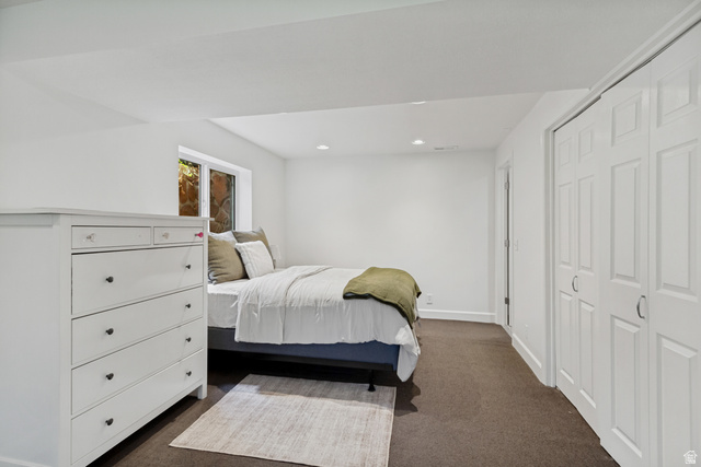 9706 Raintree Drive Sandy, UT 84092 - Photo 28 of 42 Recessed lighting, white walls, dark carpet flooring, white trim, and white bi-fold closet doors