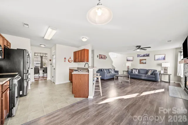 a living room with furniture and kitchen view