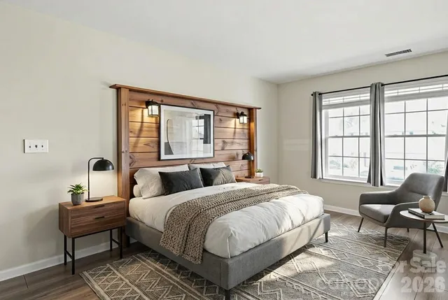 a bedroom with a bed and wooden floor