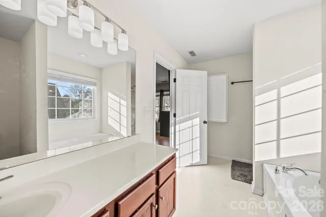 a kitchen with stainless steel appliances kitchen island granite countertop a refrigerator and a sink