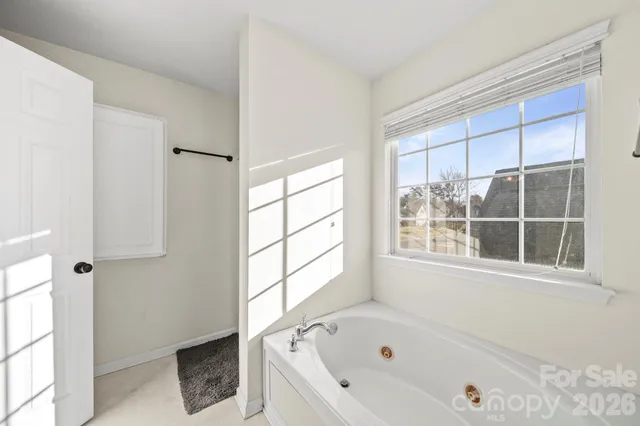 a white bath tub sitting next to a window