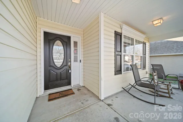 a living room with furniture a window and white walls