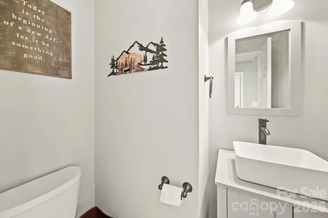 a bathroom with a sink and mirror with bathtub
